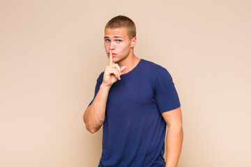 blonde  man asking for silence and quiet, gesturing with finger in front of mouth, saying shh or...