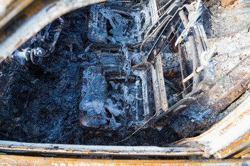 Burned down car, abstract background, selective focus. The situation of protests in the world.