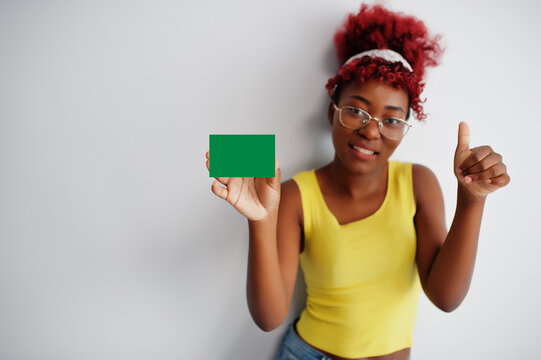African woman with afro hair hold Adamawa flag isolated on white background, show thumb up. States of Nigeria concept.