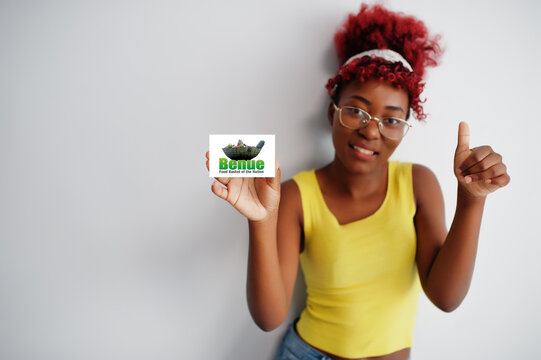 African woman with afro hair hold Benue flag isolated on white background, show thumb up. States of Nigeria concept.