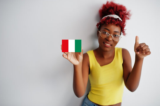 African woman with afro hair hold Nasarawa flag isolated on white background, show thumb up. States of Nigeria concept.