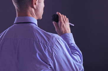 Businessman speech concept, talking with microphone in conference hall