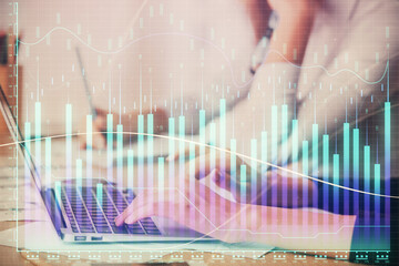 Multi exposure of woman hands typing on computer and financial chart hologram drawing. Stock market analysis concept.