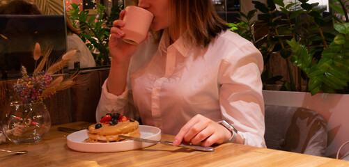girl with coffee and berry dessert