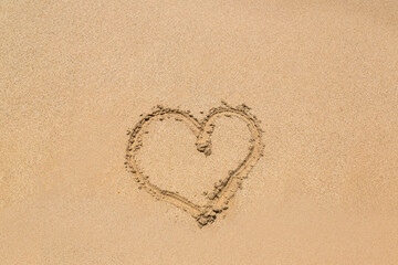 Heart symbol written in a sand