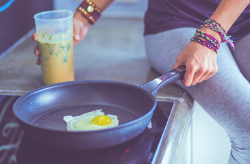 Fitness girl cooking healthy food in the kitchen. Woman. Kitchen. Cooking