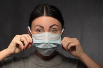 Healthy woman using medical protective mask to health protection