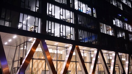 Combination of metal and glass wall material. Steel facade on columns. Abstract modern architecture. High-tech minimalist office building. Contemporary business architecture abstract fragment in night