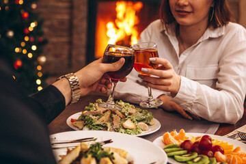 romantic atmosphere of celebration of the New Year and Christmas. Photo of holiday table, loving couple celebrating holiday at home