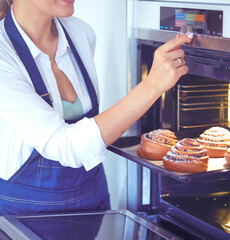 Woman cook holding plate with homemade baked goods