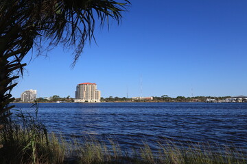 Santa Rose Island, Florida, USA - September 2020. A wonderful view with palm trees to the multi-storey hotel.