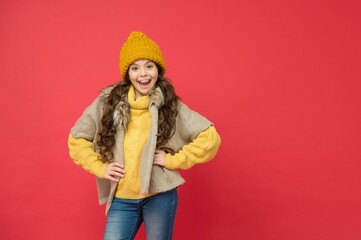 kid with happy face wearing warm winter clothing and get ready for holidays, copy space, autumn...