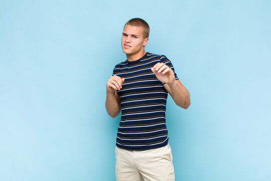 Blonde  Man Feeling Disgusted And Nauseous, Backing Away From Something Nasty, Smelly Or Stinky, Saying Yuck