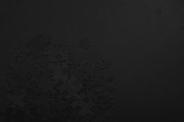 Photo of black puzzles on a black background, business background