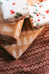 Close up and selective focus. Some gifts of different colors on a blanket. Christmas background and abstract concept