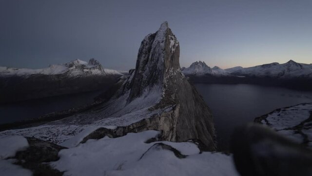 Hiker Resting With View Of Segla Mountain