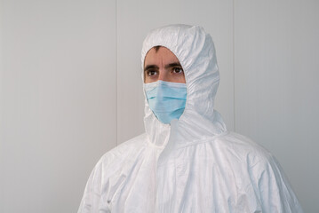 A nurse in a protective suit PPE in a hospital consultation. Coronavirus.