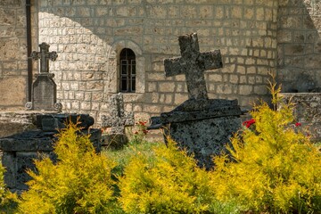 Gravestones in front of a church. Ancient stone graves in front of a monastery