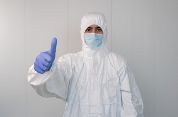 Fototapeta na wymiar A nurse in a protective suit gesturing a thumbs up. Coronavirus pandemic
