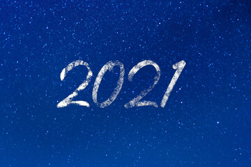 2021 year. 2021 text on a blue starry background at night. Concept of aspirations, dreams, magic, wishes, stars, universe. Banner, wallpaper, poster, billboard or greeting card with space for text.
