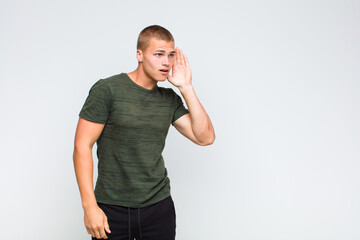 blonde  man looking serious and curious, listening, trying to hear a secret conversation or gossip,...
