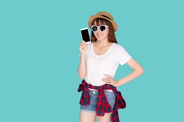 Beautiful young asian woman showing smart mobile phone for presenting something in travel summer trip in vacation isolated on blue background, asia girl holding smartphone, holiday concept.