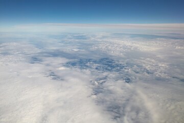 Fototapeta na wymiar Clouds seen from above on a plane flight