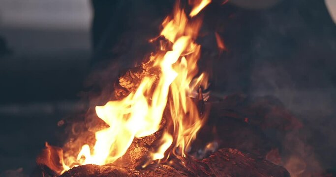 Bonfire burning trees at night. Bonfire burning brightly, heat, light, camping, big bonfire, close up bonfire flames of camping fire, burning firewood , orange fire flame and smoke