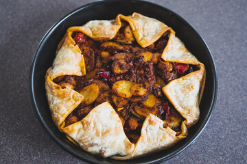 plant-based food, vegan pie with mediterranean vegetables potato and olive red pesto