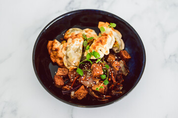 plant-based food, vegan gyozas with teriyaki vegetables and marinated tofu bites