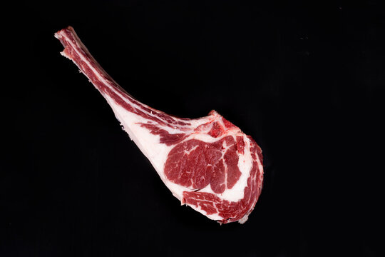 Raw Prime Rib Steak Isolated In Black Background