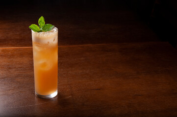 Refreshing orange drink in dark background
