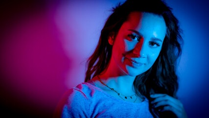 Young woman in her mid-20s - RGB colored portait shot stylish illuminated - home shooting