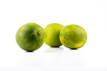 green lemons isolated on white