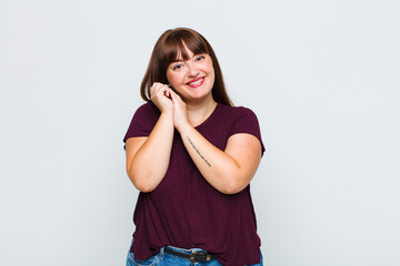 overweight woman feeling in love and looking cute, adorable and happy, smiling romantically with...