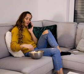 Young relaxed woman on the couch on the phone - home shooting