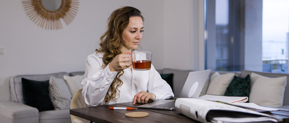 Young woman attends a conference call - home shooting