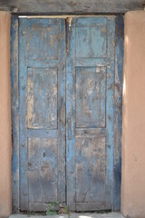 Blue wooden door in Santa Fe, New Mexico on an Adobe house. 