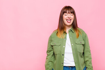 overweight woman with cheerful, carefree, rebellious attitude, joking and sticking tongue out,...