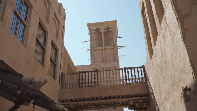 Wind Tower On Traditional Buildings In Historical Neighborhood Of Al Fahidi, Dubai UAE - Handheld, Low Angle