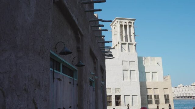 Traditional Buildings With Wind Tower In Historical Neighborhood Of Al Fahidi, Dubai UAE On A Sunny Day. - Slider