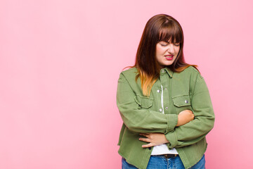 overweight woman feeling anxious, ill, sick and unhappy, suffering a painful stomach ache or flu