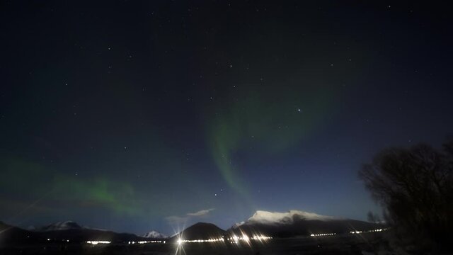 Timelapse of Northern Lights Dancing in the Sky as Seen from the Snowy Mountains