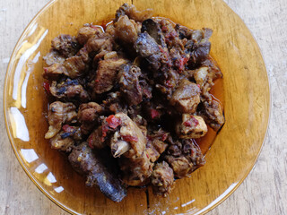 Chicken rica on a brown plate