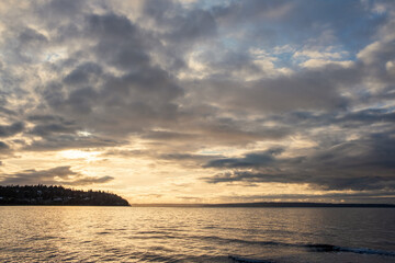 Sunset on a cloudy afternoon over a beach on the Washington coast