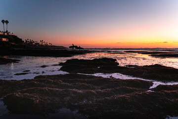Surfers at sunset 
