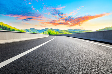 Naklejka premium Country asphalt road and green tea plantation with bamboo forest natural landscape.