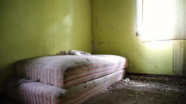 Old mattress laying on the floor in abandon house
