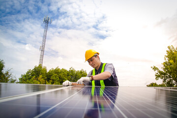 Asian technicians install panels Solar cells to produce and distribute electricity. Energy technology concept. copy space