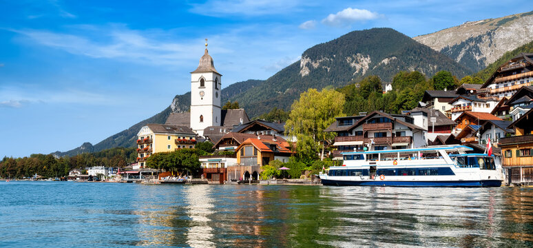 Panoramic view from the Wolfgangsee to the village St. Wolfgang with the mountains in the background